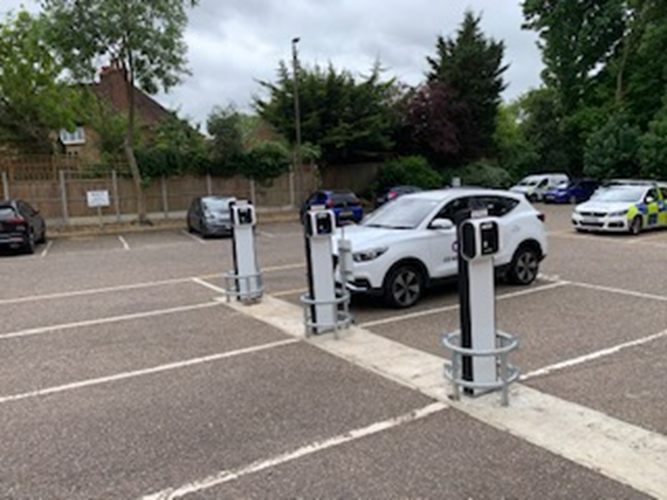 Car parked next to an electric vehicle charging point.