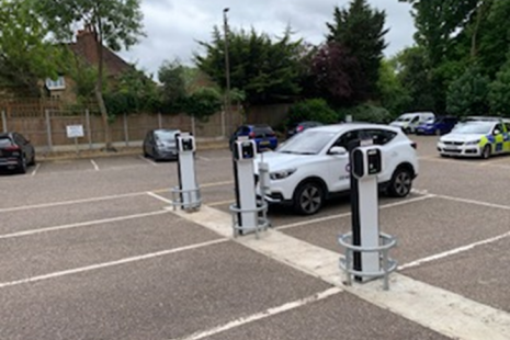 Car parked next to an electric vehicle charging point.